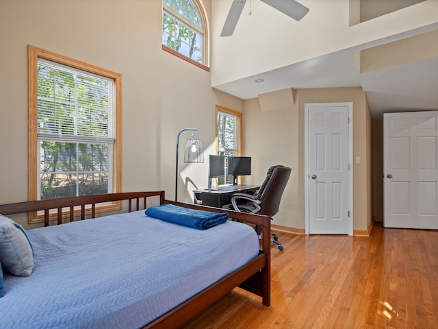 270 S Center St, Northville, MI 48167 - bedroom featuring light wood finished floors, baseboards, a high ceiling, and ceiling fan