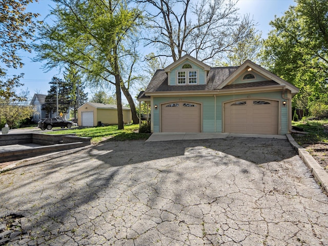 270 S Center St, Northville, MI 48167 - view of front of house featuring roof with shingles and a garage
