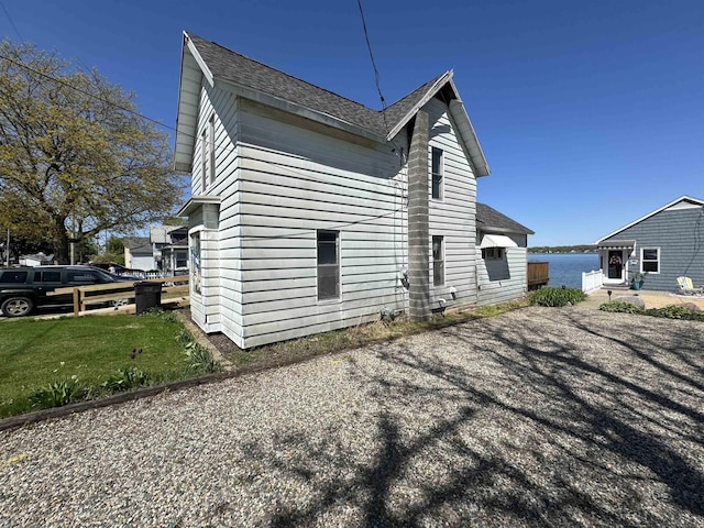 1730 Round Lake Hwy, Manitou Beach, MI 49253 - view of side of property with a shingled roof