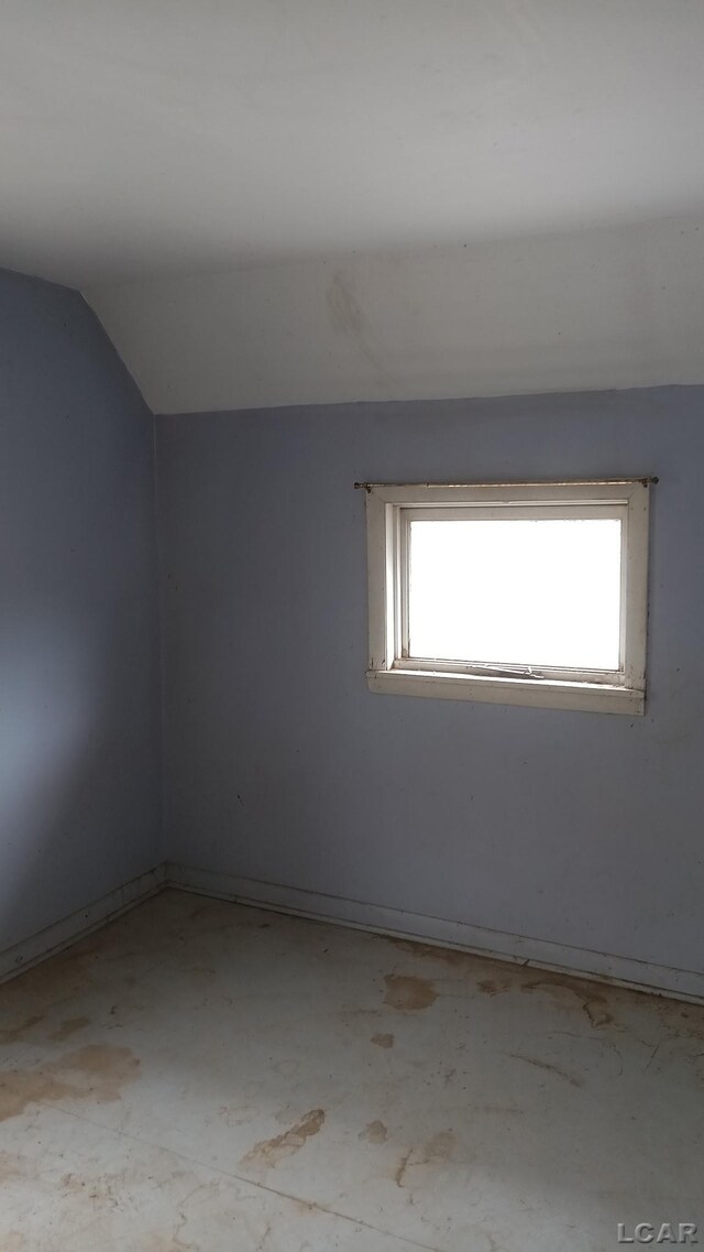 1730 Round Lake Hwy, Manitou Beach, MI 49253 - unfurnished room featuring healthy amount of natural light, lofted ceiling, and baseboards
