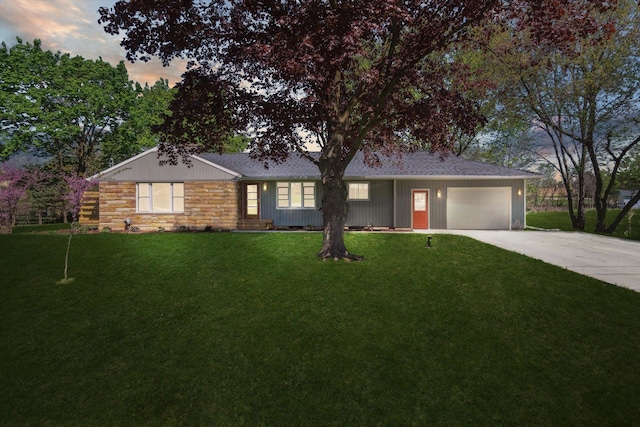 1431 E Oliver St, Owosso, MI 48867 - ranch-style house with concrete driveway, stone siding, a garage, a front lawn, and a shingled roof