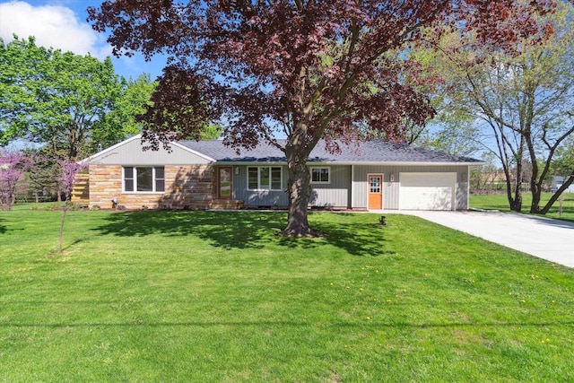 1431 E Oliver St, Owosso, MI 48867 - ranch-style house featuring concrete driveway, a garage, a front lawn, and stone siding