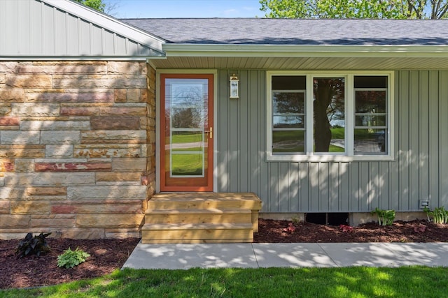 1431 E Oliver St, Owosso, MI 48867 - property entrance featuring stone siding, a shingled roof, and board and batten siding