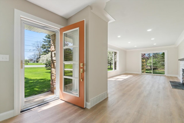 1431 E Oliver St, Owosso, MI 48867 - doorway featuring light wood-style floors, baseboards, ornamental molding, and recessed lighting