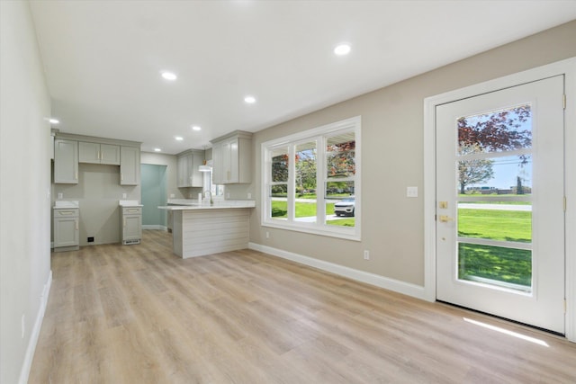 1431 E Oliver St, Owosso, MI 48867 - kitchen featuring gray cabinetry, light wood finished floors, a sink, recessed lighting, and baseboards
