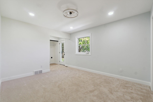 1431 E Oliver St, Owosso, MI 48867 - unfurnished room featuring light colored carpet, recessed lighting, and baseboards