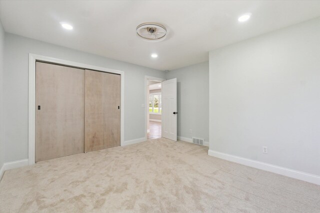 1431 E Oliver St, Owosso, MI 48867 - unfurnished bedroom with recessed lighting, carpet floors, a closet, and baseboards