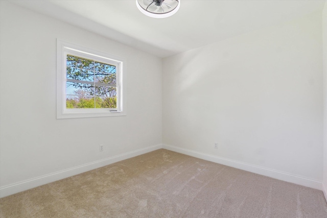 1431 E Oliver St, Owosso, MI 48867 - spare room featuring light colored carpet and baseboards