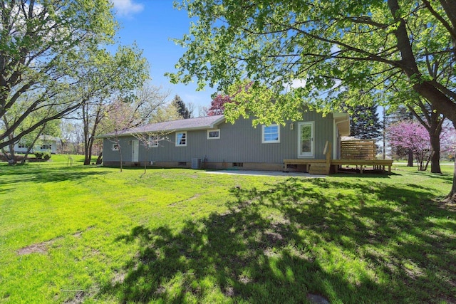 1431 E Oliver St, Owosso, MI 48867 - back of house with a lawn and cooling unit