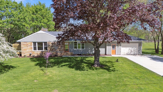 1431 E Oliver St, Owosso, MI 48867 - ranch-style home with concrete driveway, a garage, a front lawn, a chimney, and stone siding