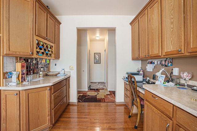 5695 Storrow Ct, Warren, MI 48092 - kitchen with light countertops, wood finished floors, brown cabinetry, and baseboards