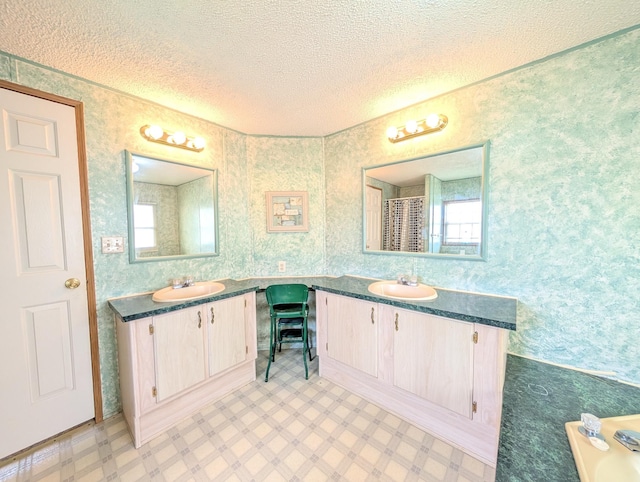 11 Fox Hound Ct, Grand Blanc, MI 48439 - bathroom with a textured ceiling, two vanities, and tile patterned floors