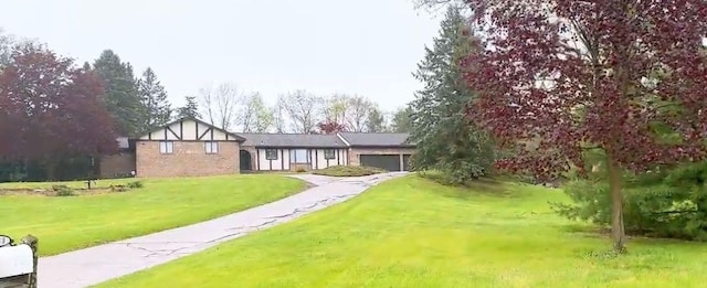 59663 Pettengill Dr, New Hudson, MI 48165 - view of front of property featuring a garage, a front lawn, and asphalt driveway