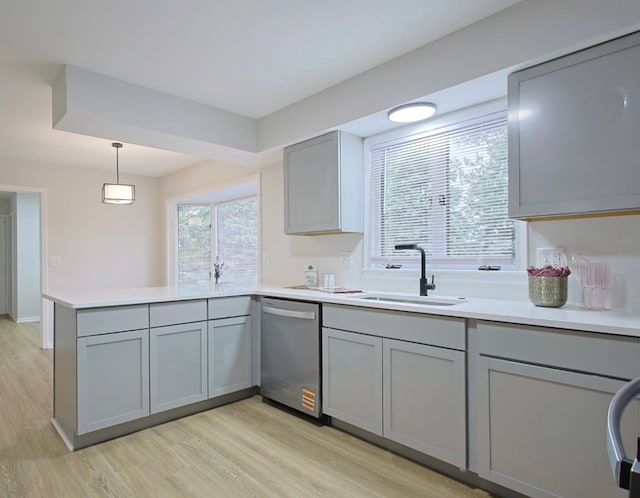 59663 Pettengill Dr, New Hudson, MI 48165 - kitchen with gray cabinetry, dishwasher, a sink, a peninsula, and light wood finished floors