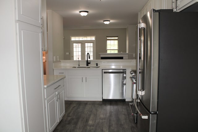 414 Old Pine Way Unit 136, Walled Lake, MI 48390 - kitchen featuring appliances with stainless steel finishes, a sink, light countertops, white cabinets, and dark wood finished floors