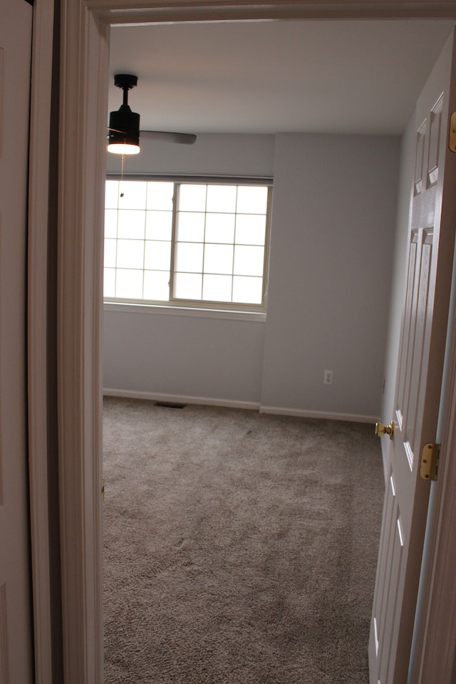 414 Old Pine Way Unit 136, Walled Lake, MI 48390 - empty room featuring carpet, ceiling fan, and baseboards