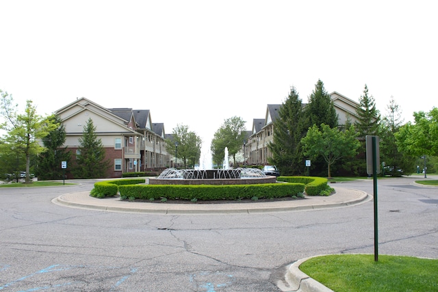 414 Old Pine Way Unit 136, Walled Lake, MI 48390 - view of asphalt road with traffic signs, curbs, and a residential view