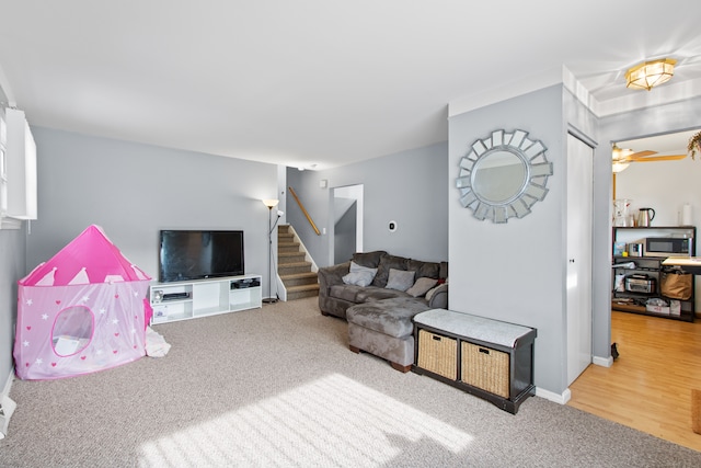 carpeted living room with stairs