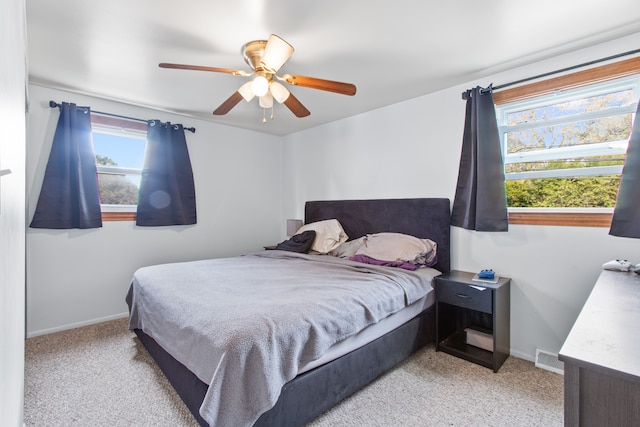 carpeted bedroom with baseboards and a ceiling fan