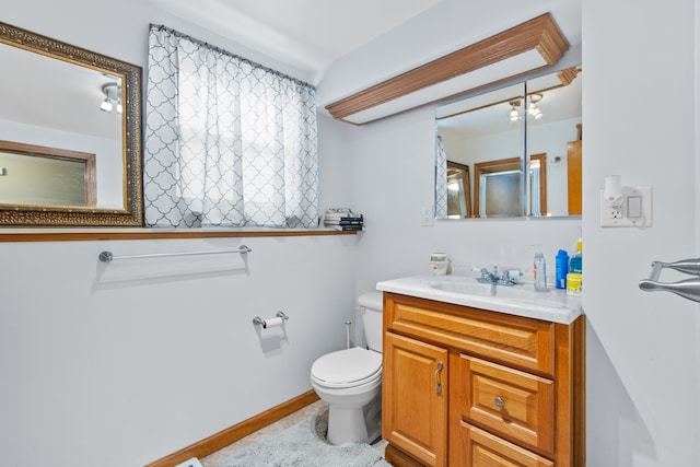 bathroom featuring toilet and vanity