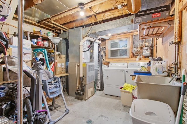 unfinished basement featuring washing machine and dryer and heating unit