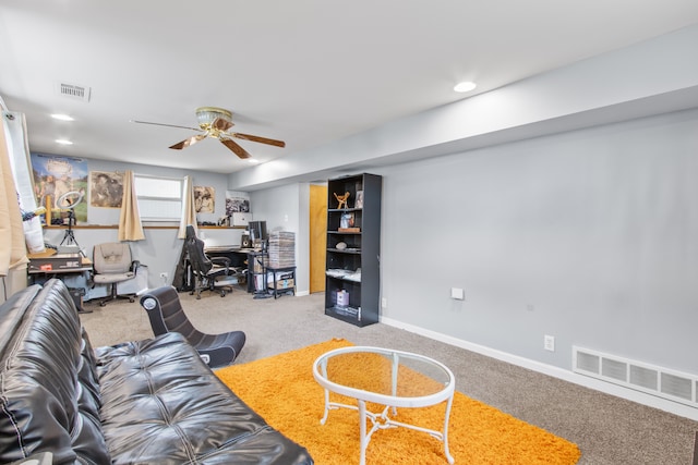 carpeted living area with a ceiling fan and baseboards