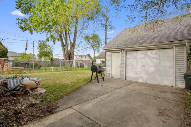 view of yard featuring concrete driveway, a garage, and an outdoor structure