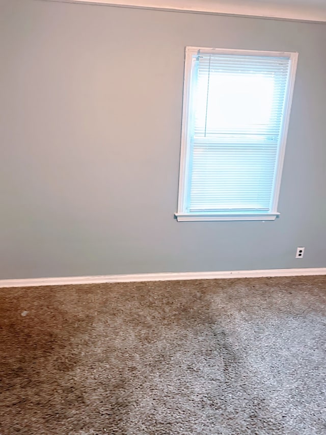 spare room with baseboards