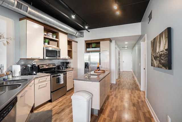 12 Washington Ave Unit 8, Grand Haven, MI 49417 - kitchen featuring open shelves, appliances with stainless steel finishes, and light wood-style floors