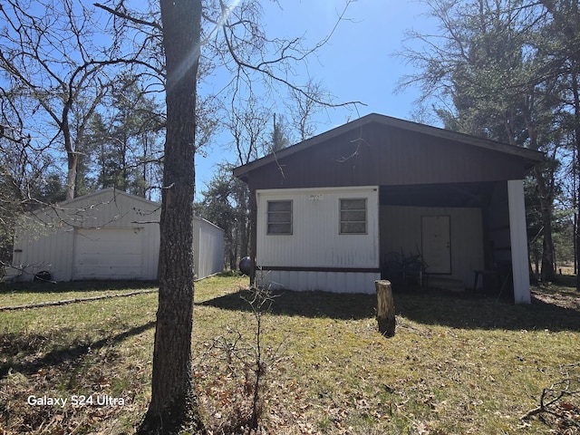 8656 N Dog Patch Dr, Irons, MI 49644 - view of home's exterior featuring a yard and an outbuilding