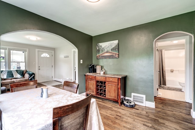 132 Jerome Ave, Ypsilanti, MI 48198 - dining room with arched walkways, wood finished floors, and baseboards
