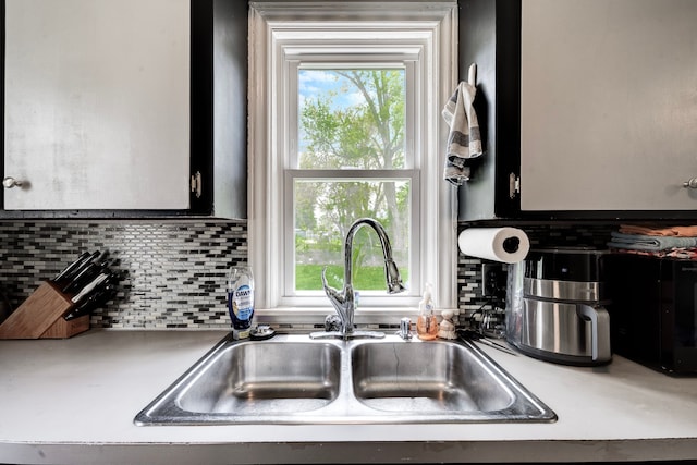 132 Jerome Ave, Ypsilanti, MI 48198 - kitchen featuring a sink, backsplash, plenty of natural light, and light countertops