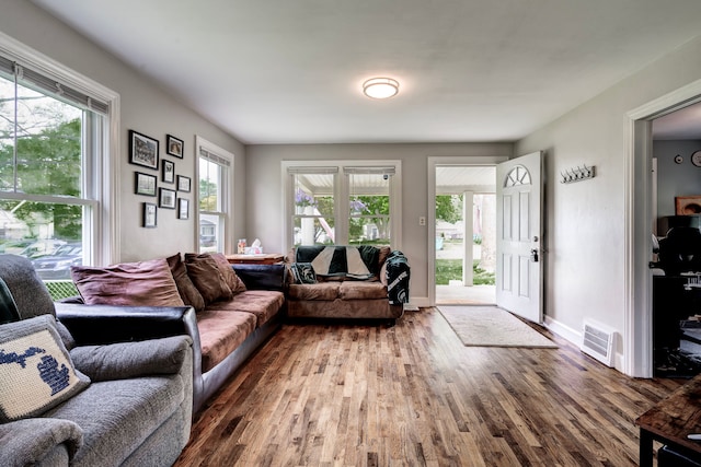 132 Jerome Ave, Ypsilanti, MI 48198 - living area with wood finished floors, healthy amount of natural light, and baseboards