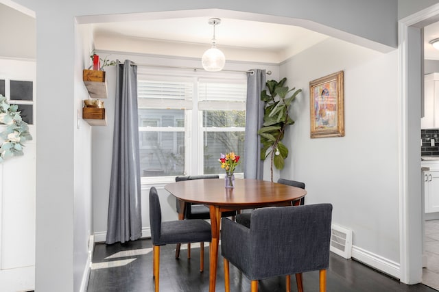 dining room with dark wood finished floors and baseboards