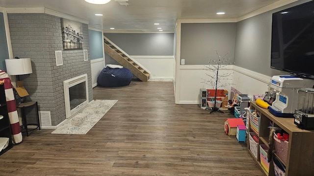 2726 Horton Ct, Niles, MI 49120 - rec room featuring ornamental molding, wainscoting, a fireplace, wood finished floors, and recessed lighting
