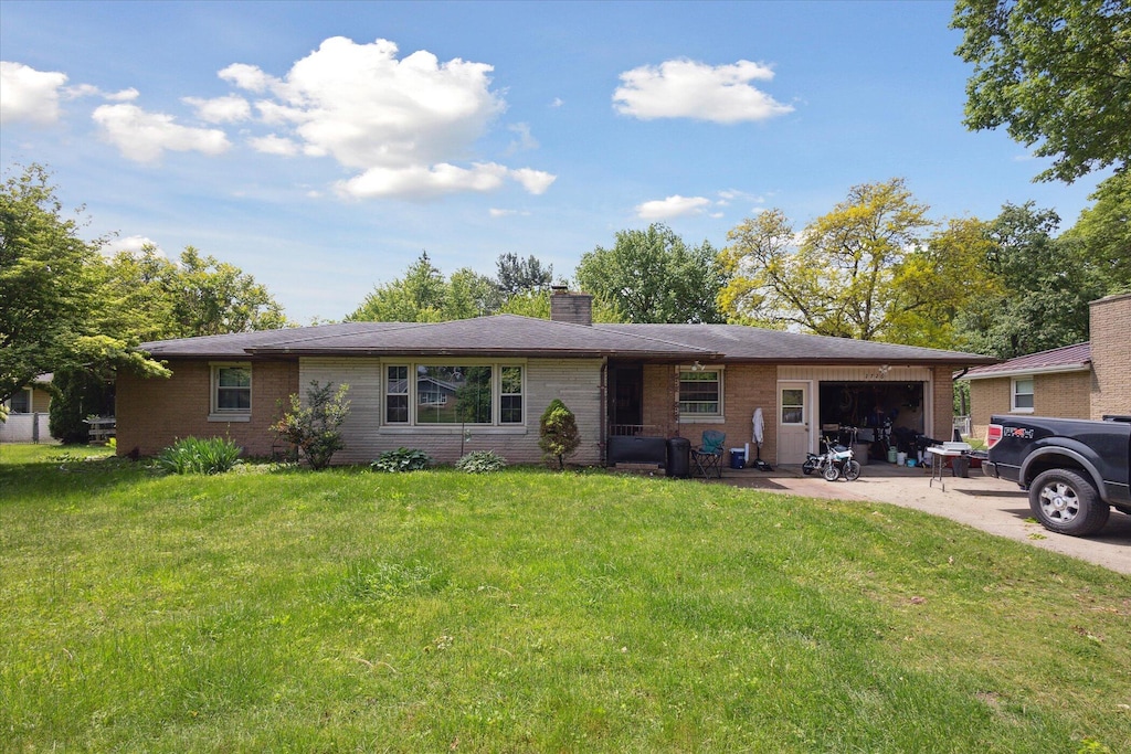 2726 Horton Ct, Niles, MI 49120 - ranch-style house featuring a garage, brick siding, concrete driveway, and a chimney