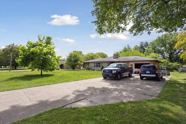 2726 Horton Ct, Niles, MI 49120 - ranch-style home with concrete driveway, a front lawn, a garage, and a chimney