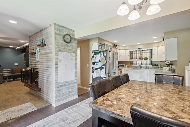2726 Horton Ct, Niles, MI 49120 - dining space featuring a chandelier, recessed lighting, dark wood-style flooring, and a fireplace