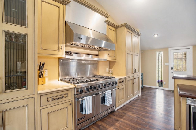 6280 Gleason Rd, Saugatuck, MI 49453 - kitchen with double oven range, dark wood-style flooring, baseboards, wall chimney exhaust hood, and decorative backsplash