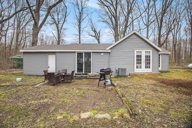 6280 Gleason Rd, Saugatuck, MI 49453 - back of house featuring central AC, a patio area, french doors, and roof with shingles