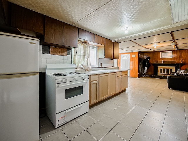 8320 Nightingale St, Dearborn Heights, MI 48127 - kitchen featuring white appliances, wooden walls, light countertops, light tile patterned flooring, and open floor plan