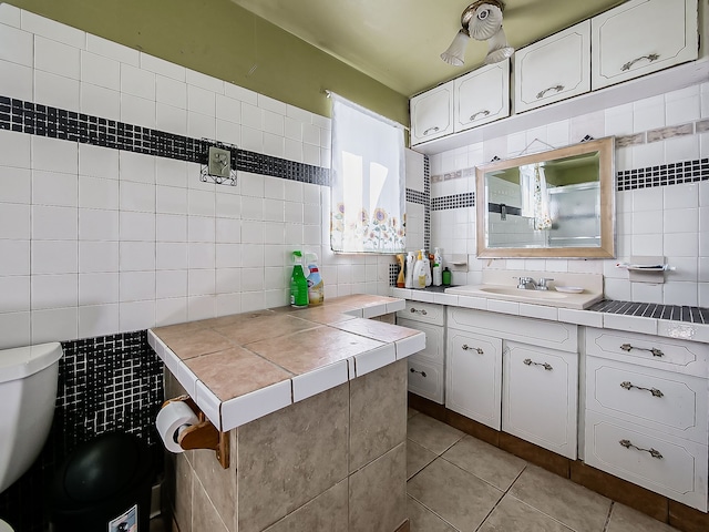 8320 Nightingale St, Dearborn Heights, MI 48127 - kitchen featuring tile counters, tile walls, tasteful backsplash, light tile patterned flooring, and white cabinetry