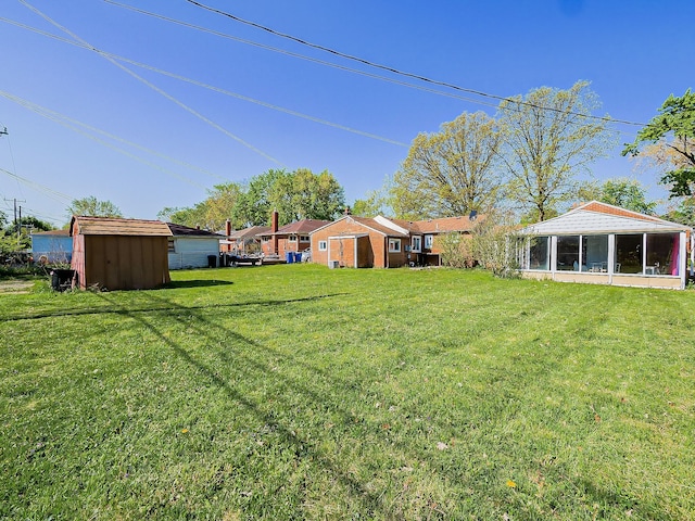 8320 Nightingale St, Dearborn Heights, MI 48127 - view of green lawn with a sunroom, a storage unit, and an outdoor structure