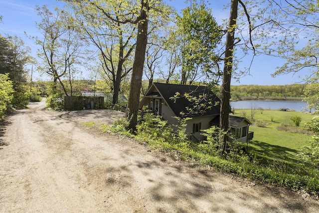 9458 Edwin Markham Rd, Brooklyn, MI 49230 - view of side of home with a water view and a lawn