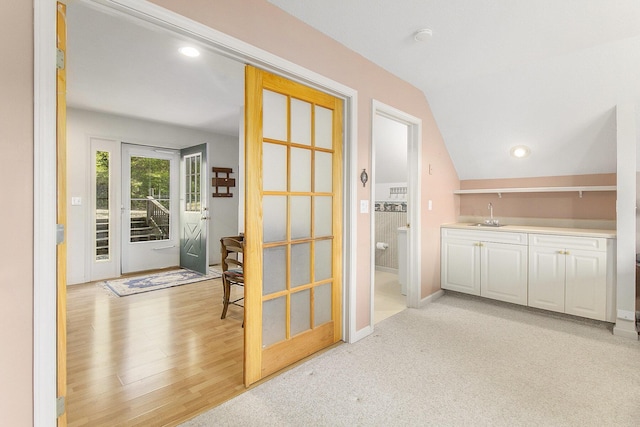 9458 Edwin Markham Rd, Brooklyn, MI 49230 - doorway with bar with sink, lofted ceiling, light wood-style flooring, and baseboards