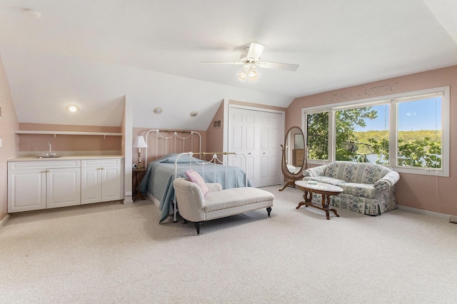 9458 Edwin Markham Rd, Brooklyn, MI 49230 - bedroom featuring light colored carpet, vaulted ceiling, bar with sink, baseboards, and a ceiling fan