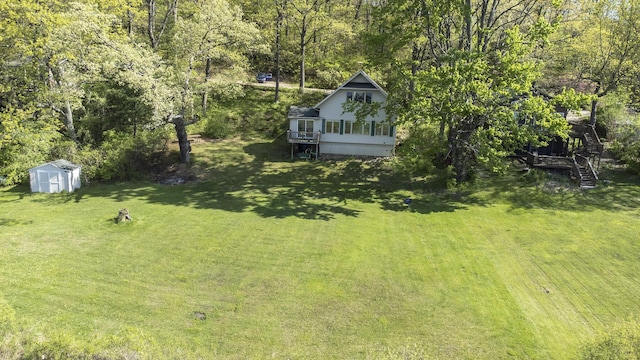 9458 Edwin Markham Rd, Brooklyn, MI 49230 - view of green lawn with a storage shed, an outdoor structure, and stairs