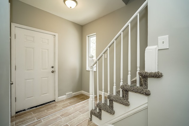 17344 Wisconsin St, Detroit, MI 48221 - entrance foyer with wood tiled floors, stairs, and baseboards