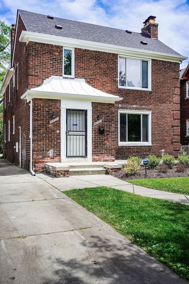 17344 Wisconsin St, Detroit, MI 48221 - view of front of property featuring brick siding, a chimney, and roof with shingles