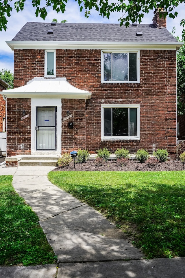 17344 Wisconsin St, Detroit, MI 48221 - view of front of property featuring brick siding, a chimney, and a front lawn